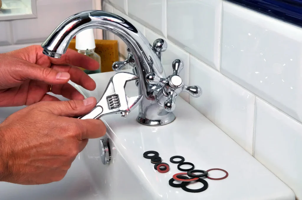 Plumber performing maintenance on a bathroom faucet in Hialeah