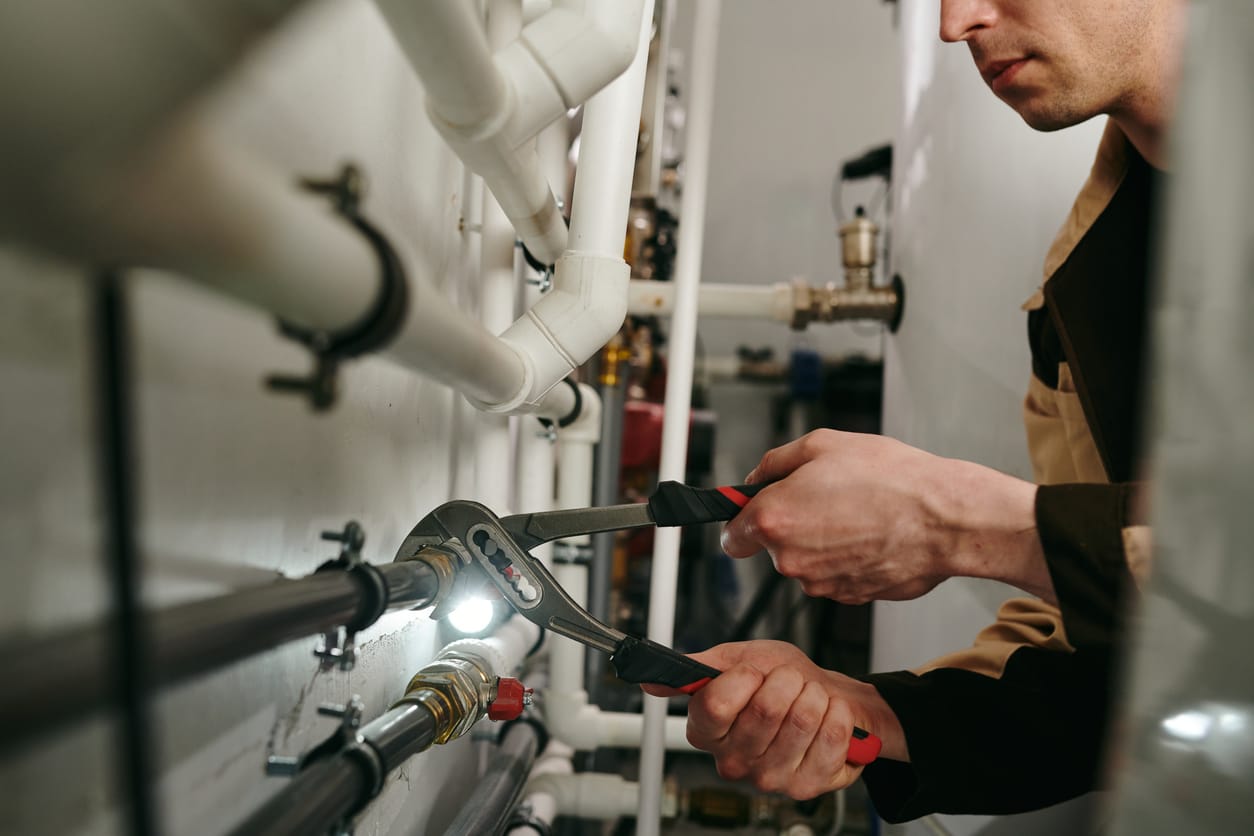 Plumbers maintaining commercial plumbing pipes in Hialeah