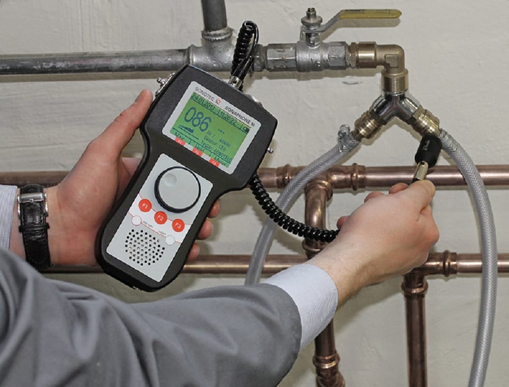 Plumber testing pipes with electronic leak detection equipment in Hialeah