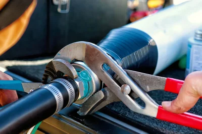 Technician tightening an industrial pipe connection in Hialeah