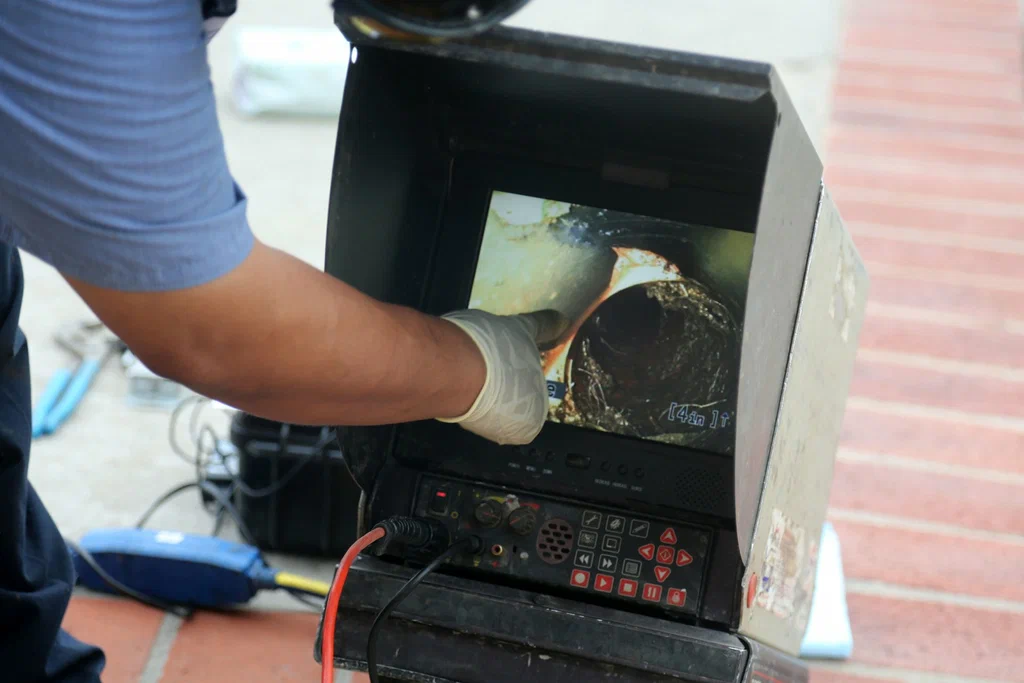Technician viewing a drain inspection camera in Hialeah