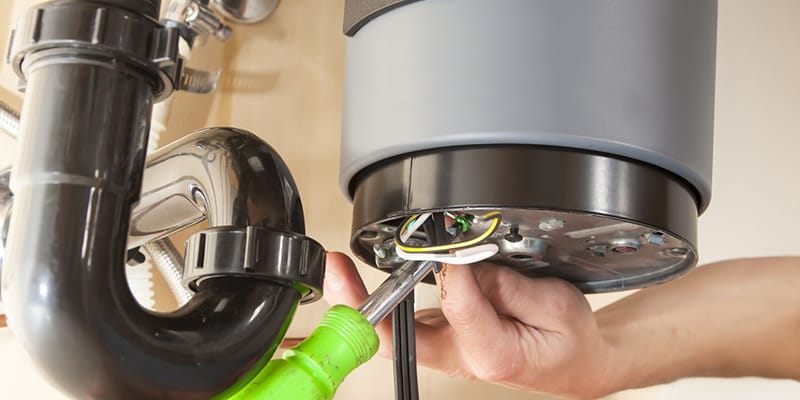 Technician repairing the heating element of a water heater in Hialeah