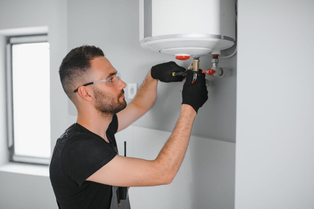 Technician performing water heater maintenance in Hialeah