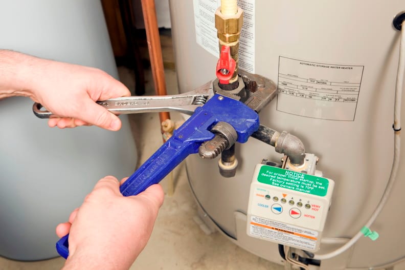 Plumber repairing a water heater valve in Hialeah